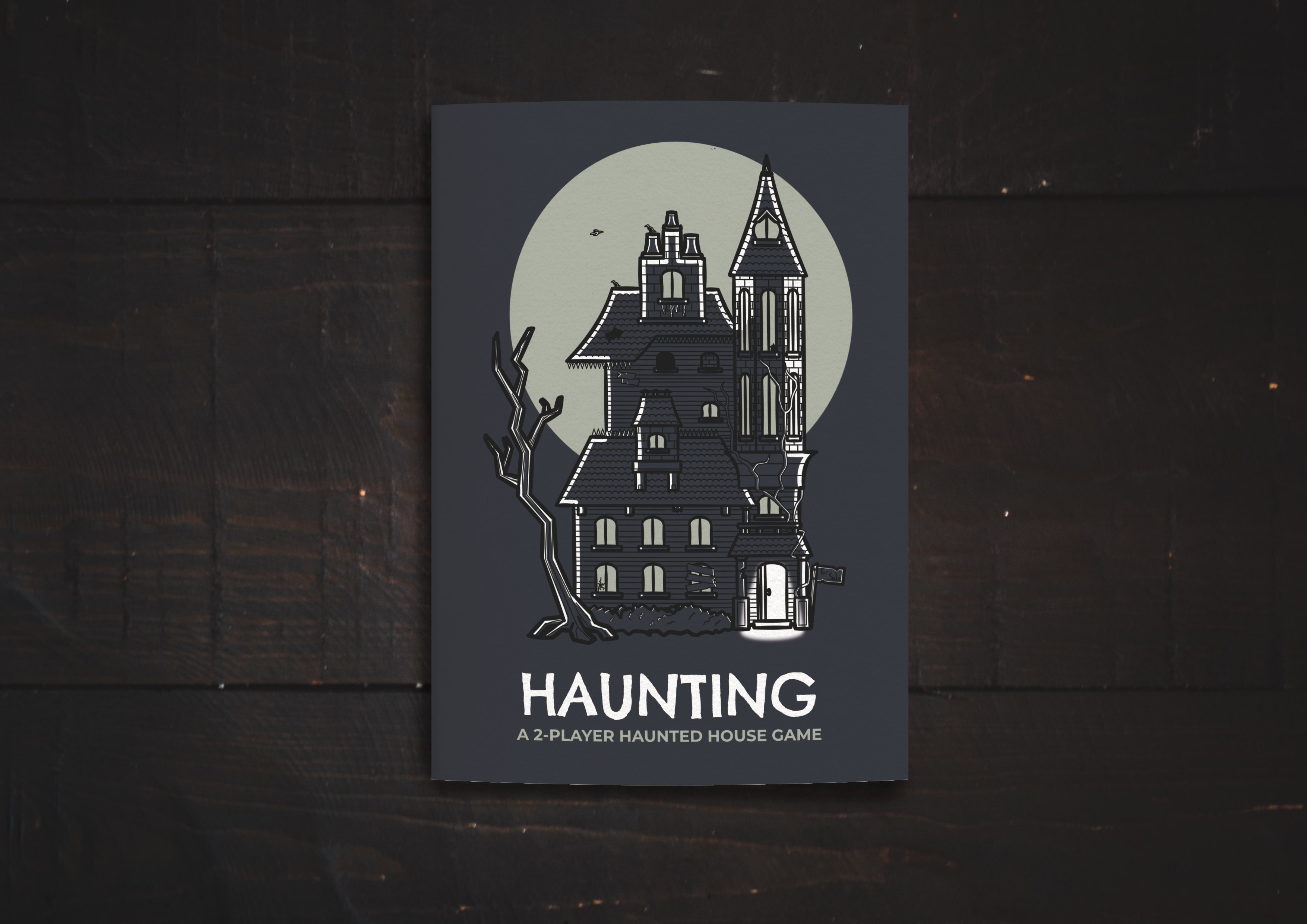 Haunting, the cover of a navy-blue zine with a drawing of a haunted house on the front.